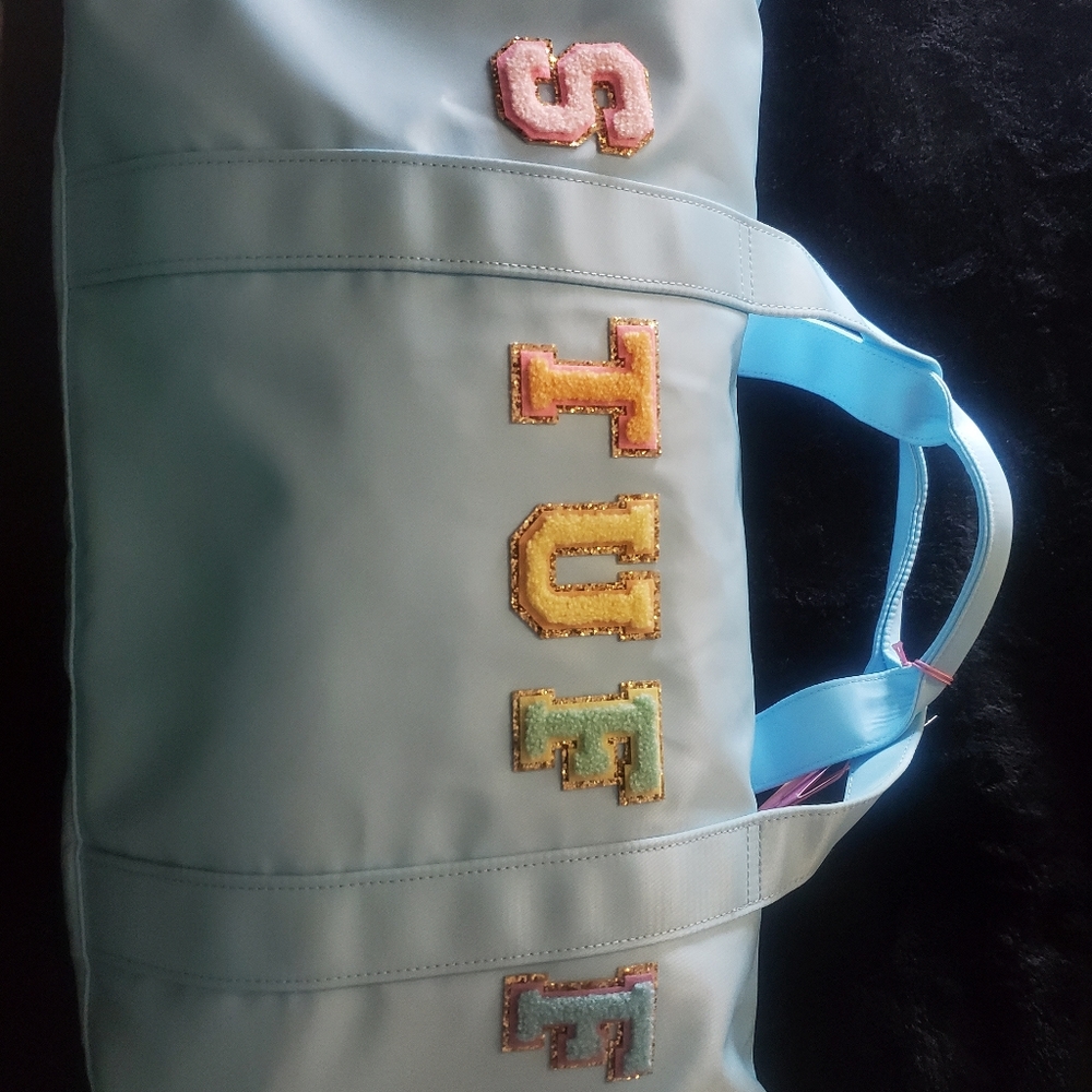 STONEY CLOVER LANE X TARGET COLLABORATION DUFFLE BAG WITH DETACHABLE STRAP.